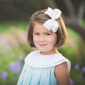 A young girl in a dress from Southern Belles in Mount Pleasant, South Carolina
